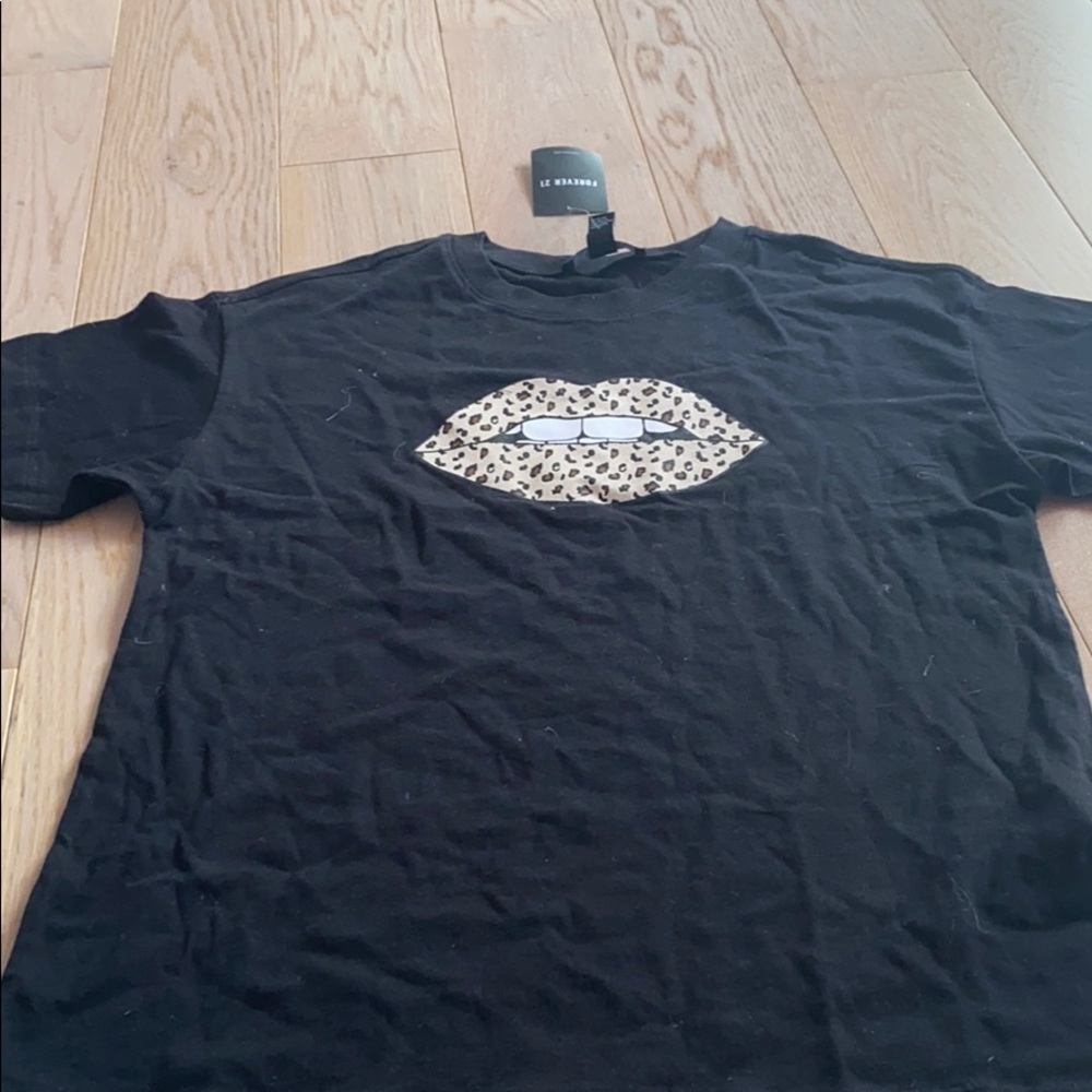 A black top with cheetah lips
